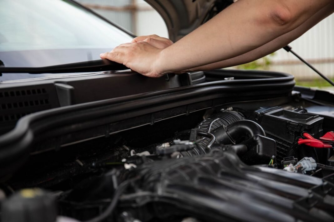 pexels-photo-8478201-8478201 Close-up of hands working on car engine. Detailed view of automotive repair.