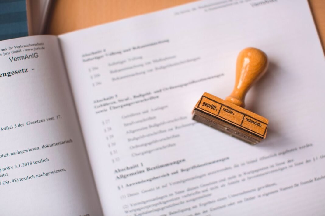 pexels-photo-9858904-9858904 Close-up of a legal document with a wooden stamp placed on top, highlighting verification.