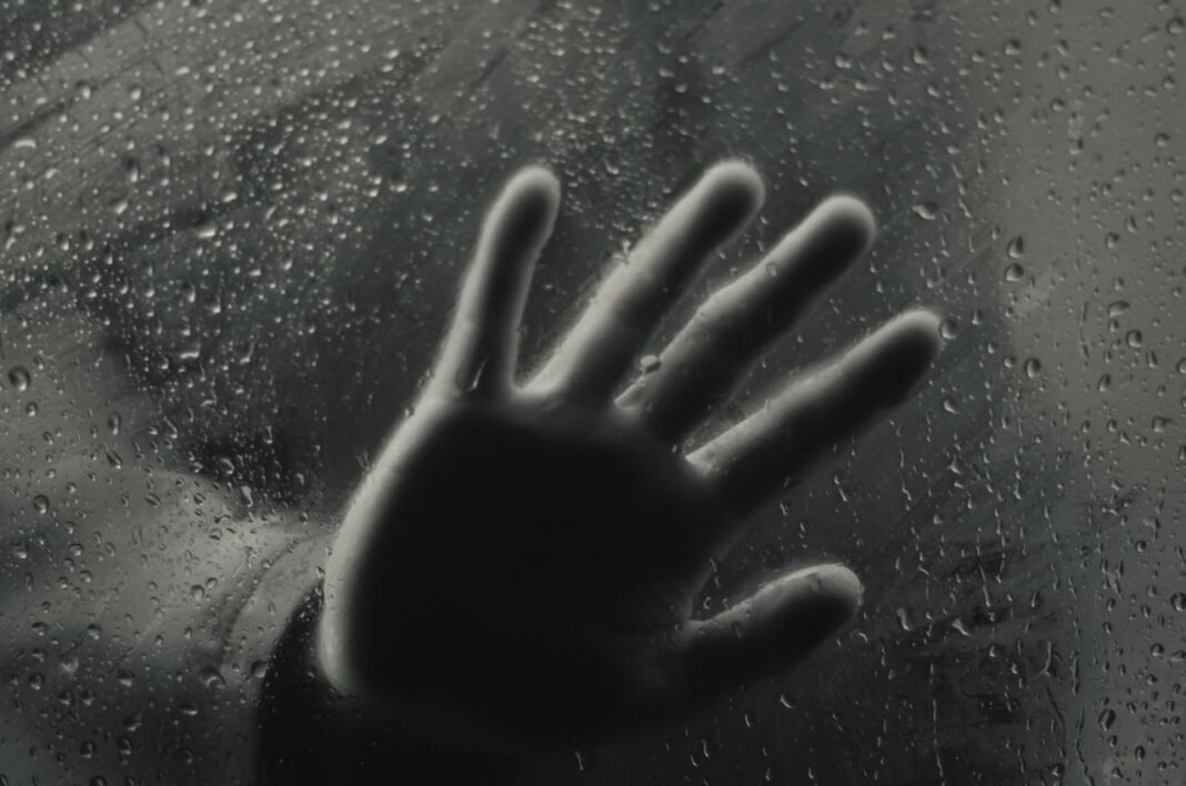 pexels-photo-4063235-4063235 Black and white through glass view of crop anonymous hand of person touching wet surface with pure drips